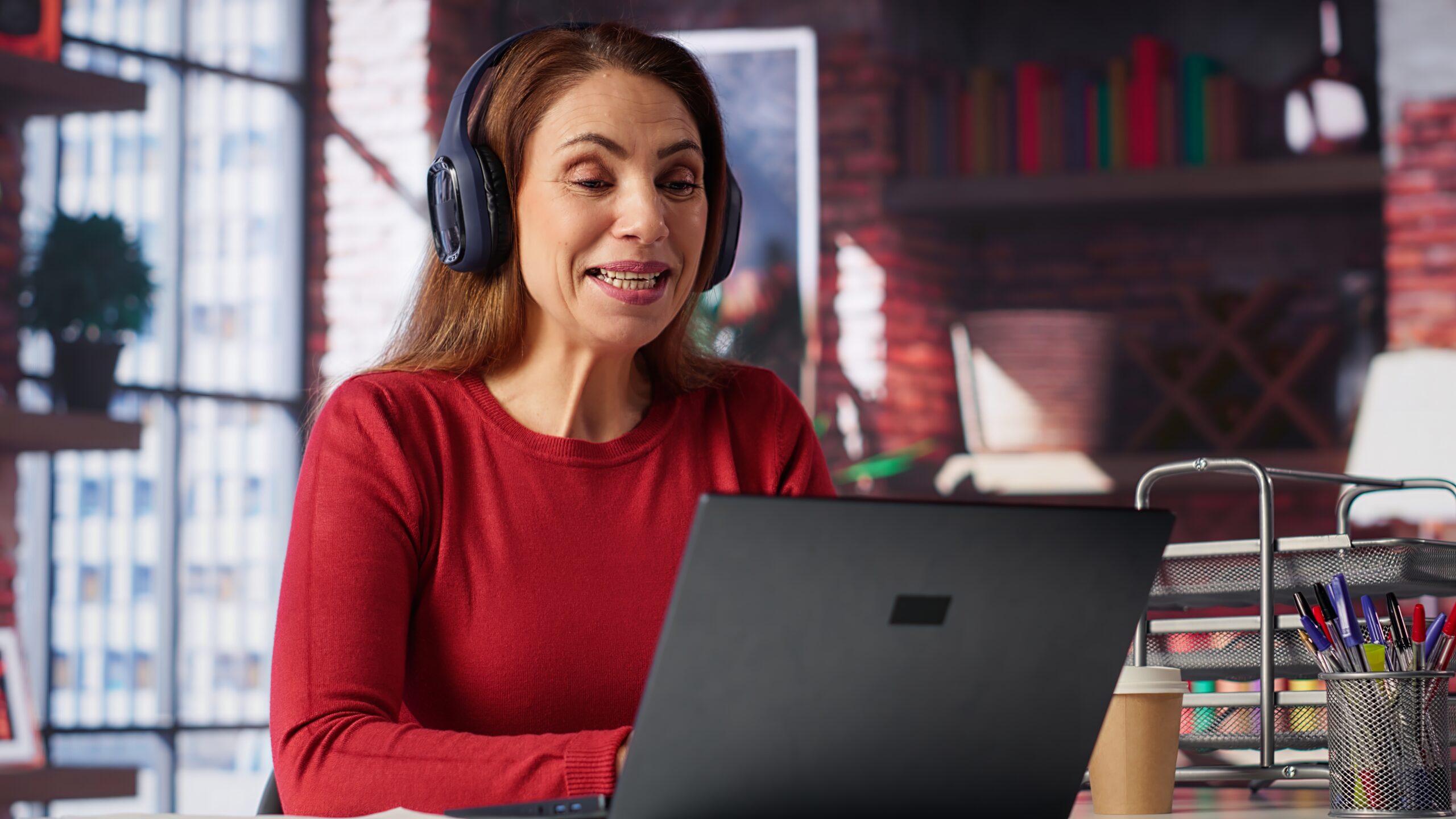 Joyful woman hosting a virtual family meeting online via video conference